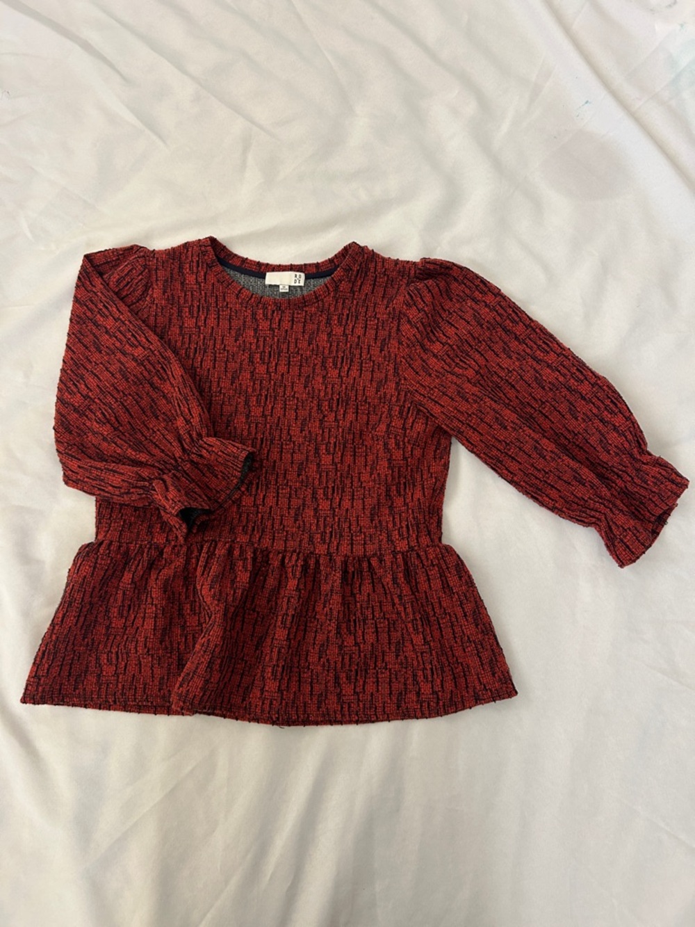 Anthropologie:  Ro & De,  Rust & navy Textured Peplum Long-Sleeve Top